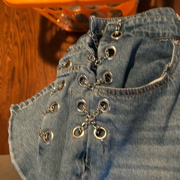 Forever21 denim blue jeans with grommets and chains on each side. - Picture 2 of 6